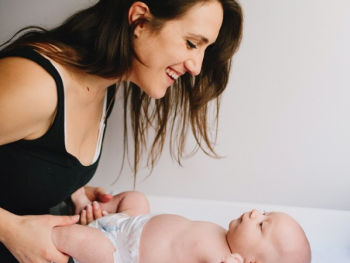 Mother with baby smiling down at her.